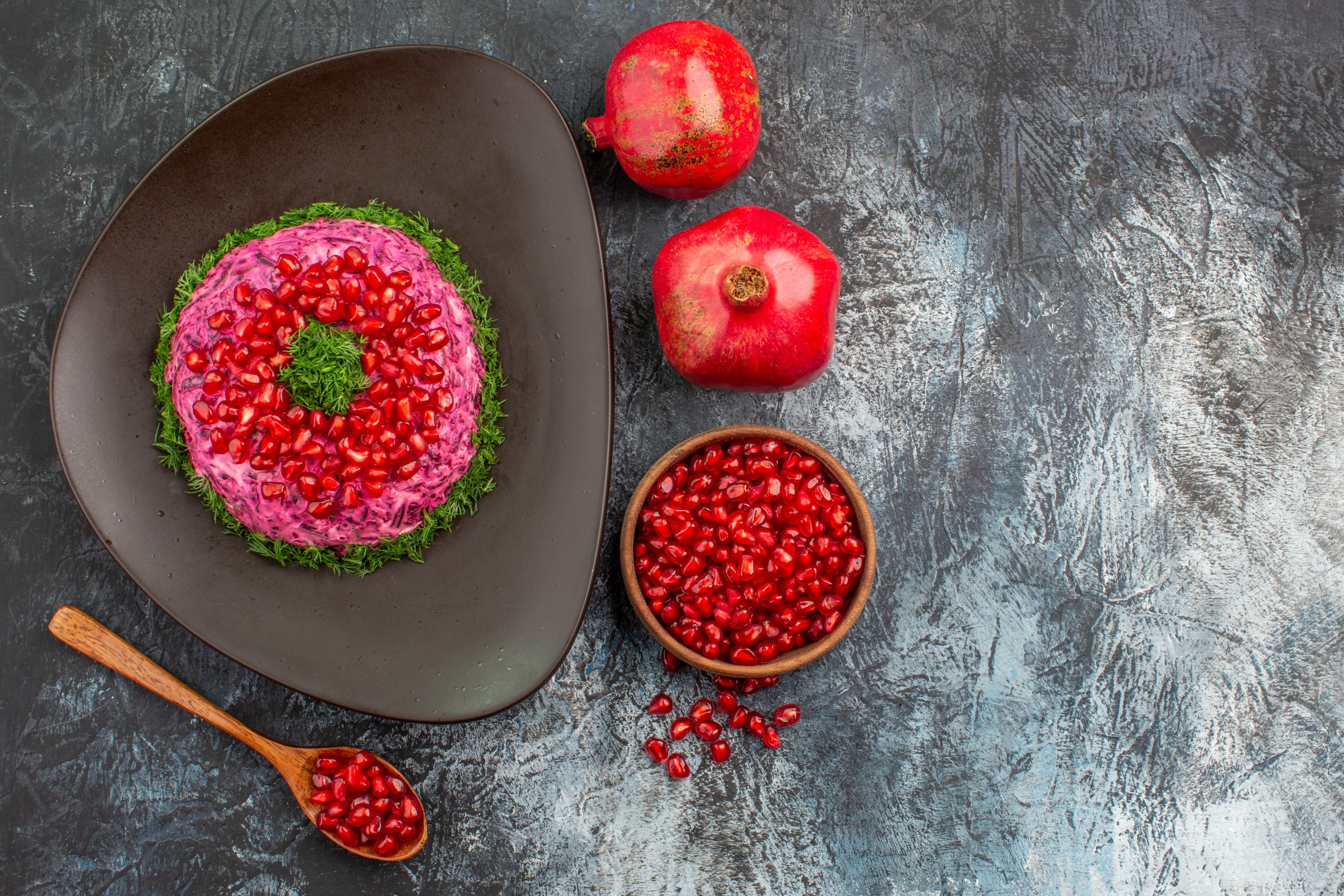 pomegranate seeds spoon appetizing dish with herbs